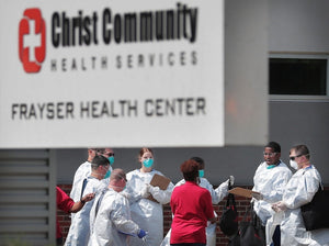 Christ Community staff, medical technicians and National Guard medics prepare to start a long day of COVID-19 testing as hundreds of Memphians line up at the Christ Community testing site in Frayser on April 25, 2020. (Jim Weber/Daily Memphian)